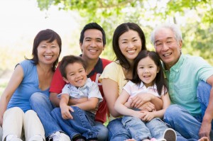 Extended family sitting outdoors smiling