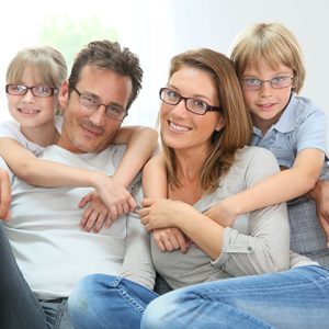 Portrait of happy family of four wearing eyeglasses